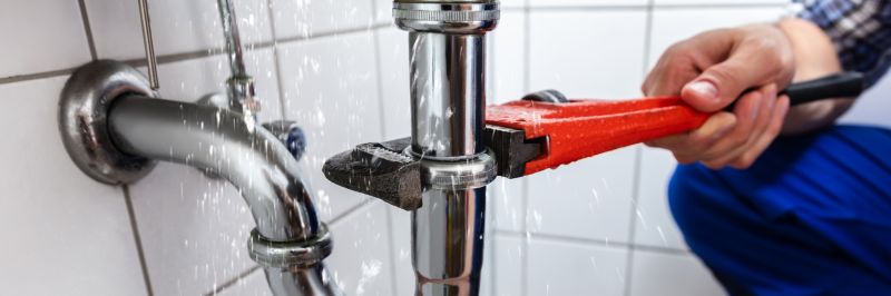 Plumber Fixing Leaking Pipe